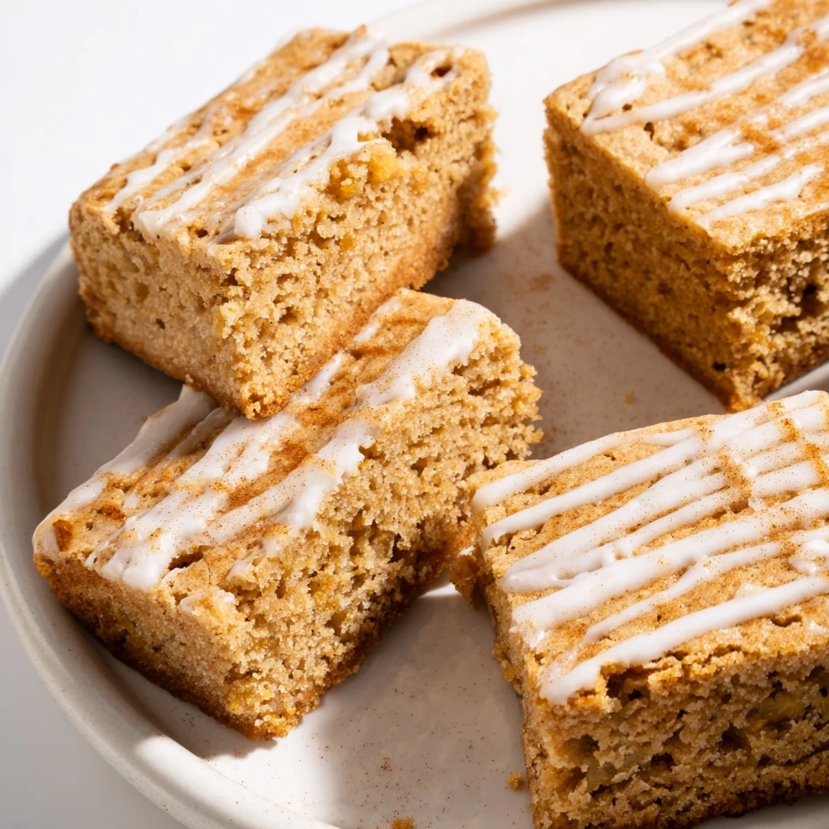 Warm gingerbread bars infused with chai spices, topped with sweet glaze delight.  