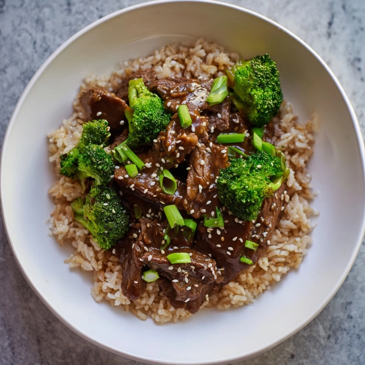 Close-up of slow-cooker beef & broccoli, showing tender beef and vibrant broccoli florets in savory sauce.