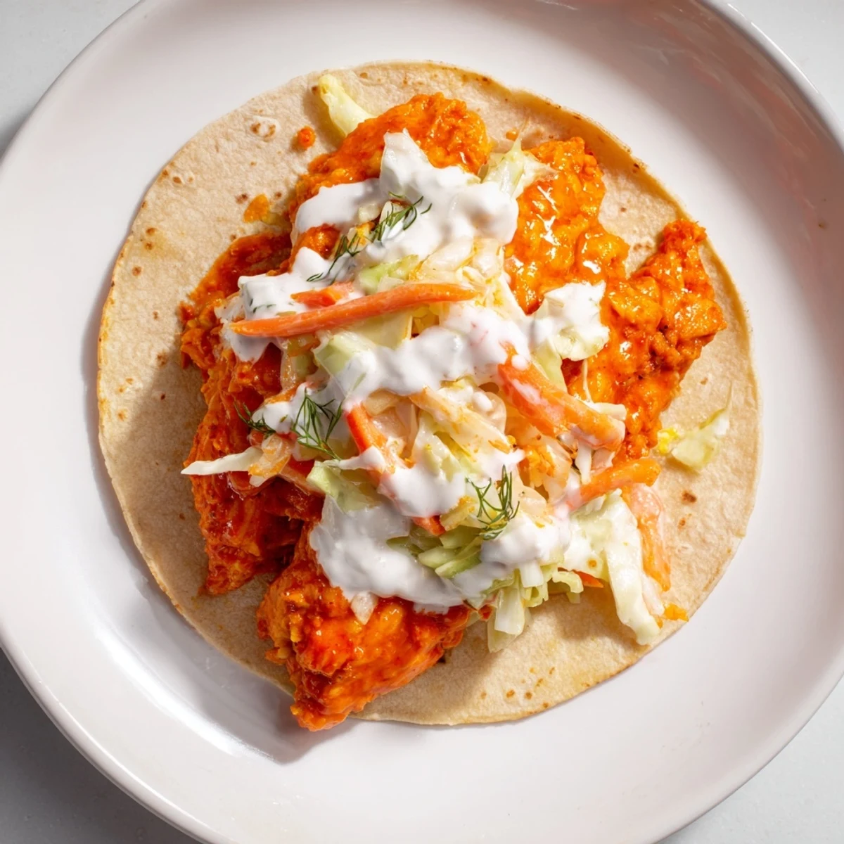 Golden, crispy Buffalo Chicken Smash Burger Tacos are topped with cool, creamy ranch slaw, a perfect bite.
