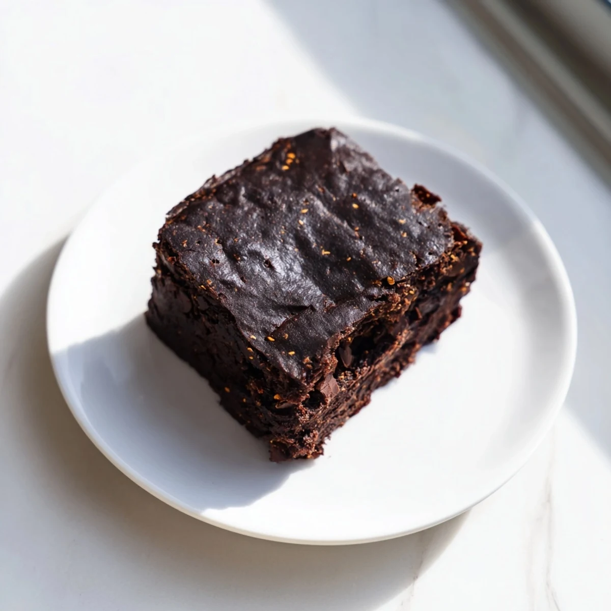 Warm, gooey Pumpkin Workout Brownies offer a delightful blend of chocolate and pumpkin spice.