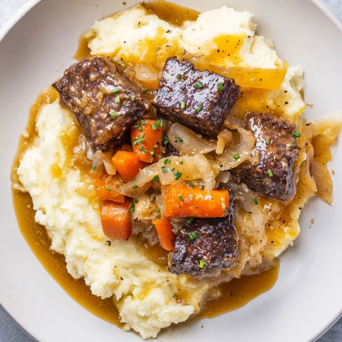 Steaming bowl of Fall Apple Cider Beef Stew Mash with creamy cheddar potatoes, ready to eat.