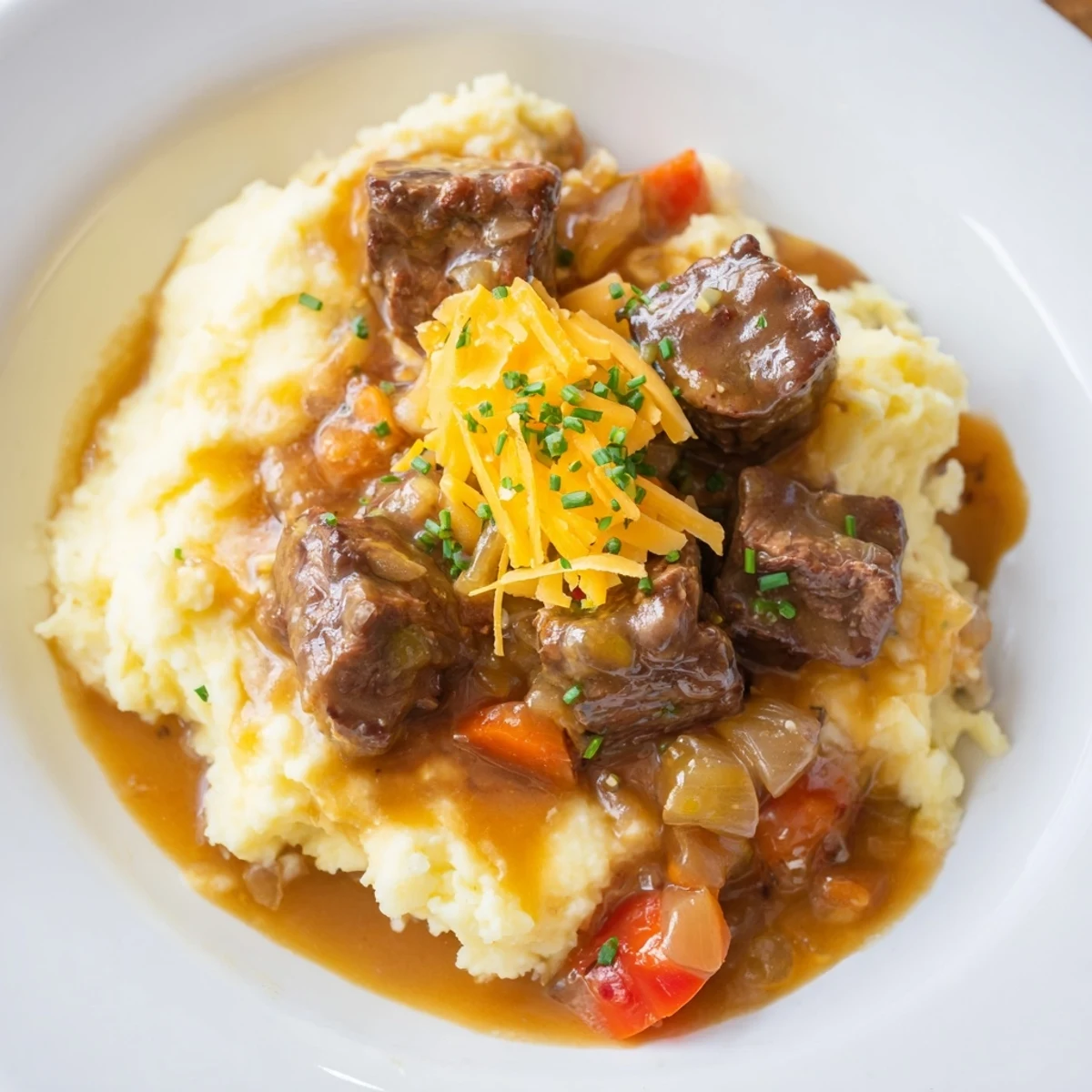 Hearty Fall Apple Cider Beef Stew Mash, with tender beef and vegetables over cheesy mashed potatoes.