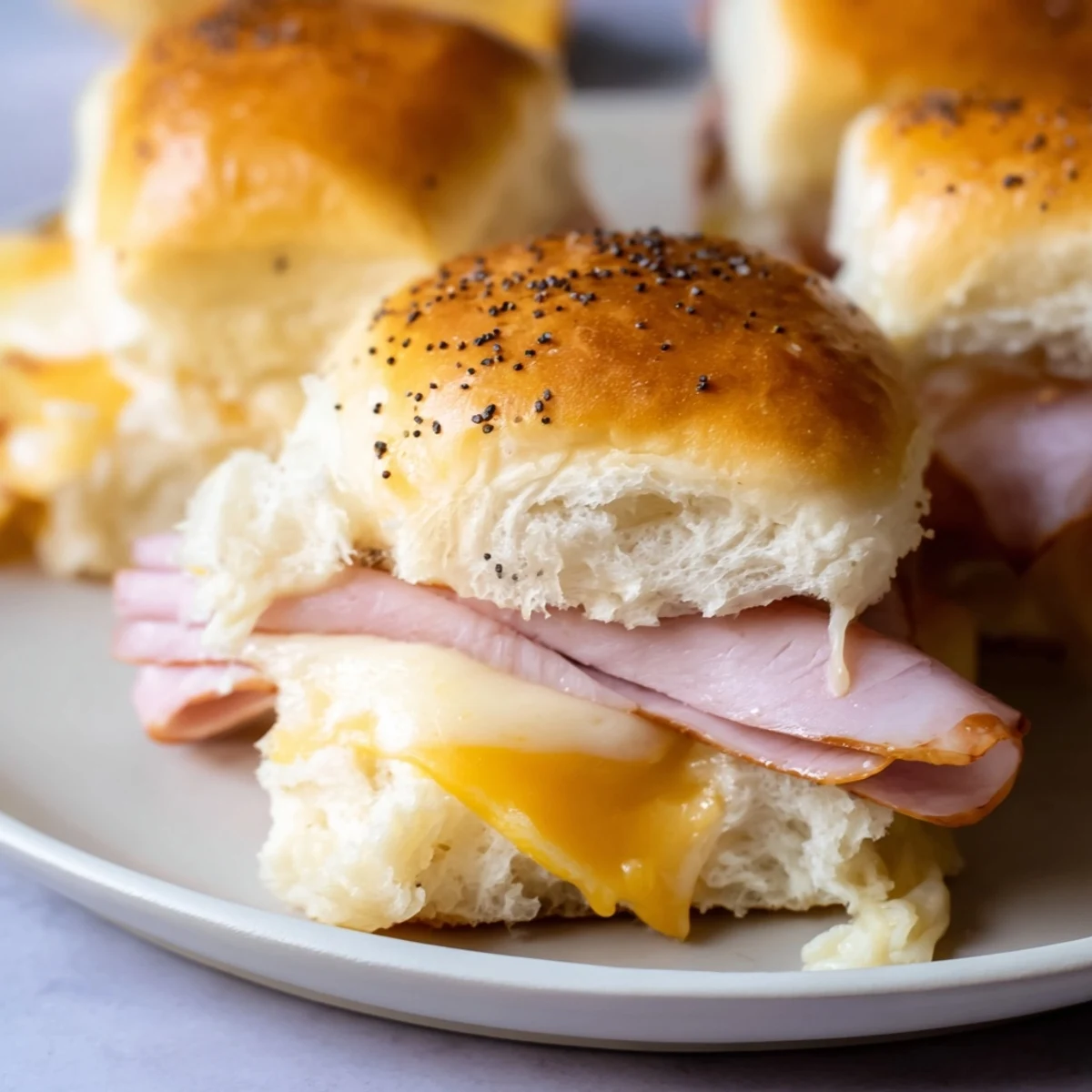 Golden, melty ham and cheese sliders, baked to a perfect crisp, perfect for sharing at a party.