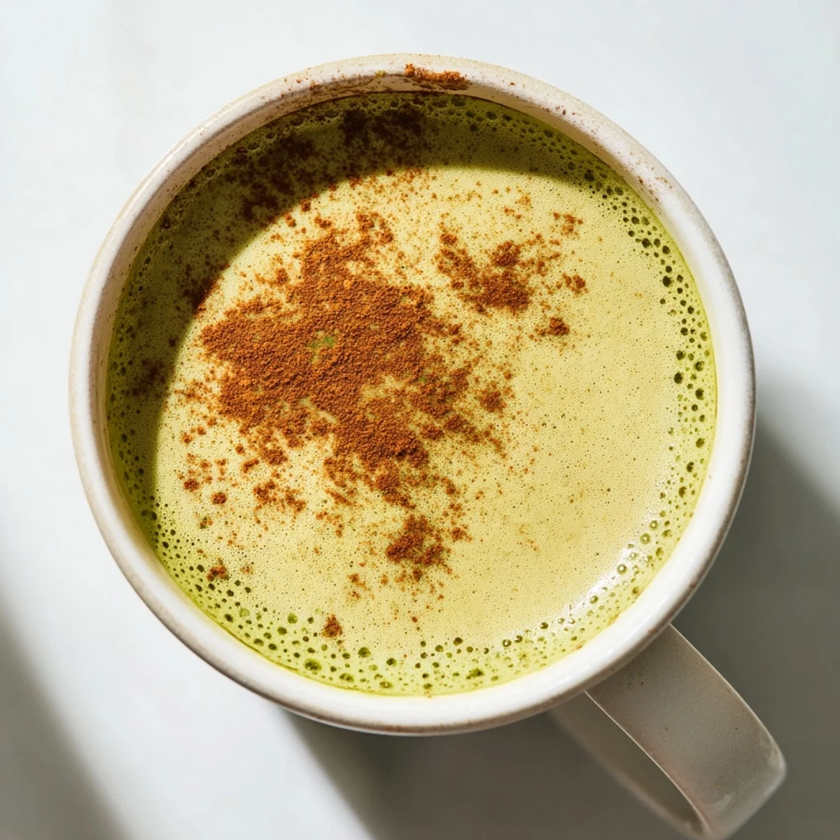 Steaming Cinnamon Maple Oat Milk Matcha Latte recipe, creamy and warmly spiced dairy-free comfort.
