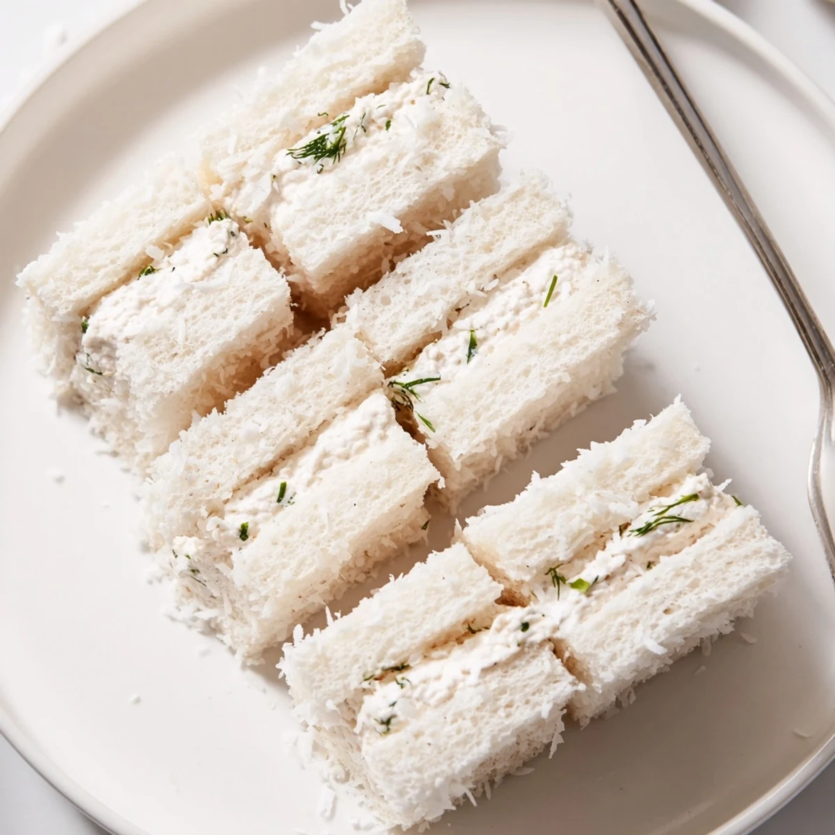 Snowball Tea Sandwich Bites: Creamy, coconut-covered bites perfect for your holiday tea party.