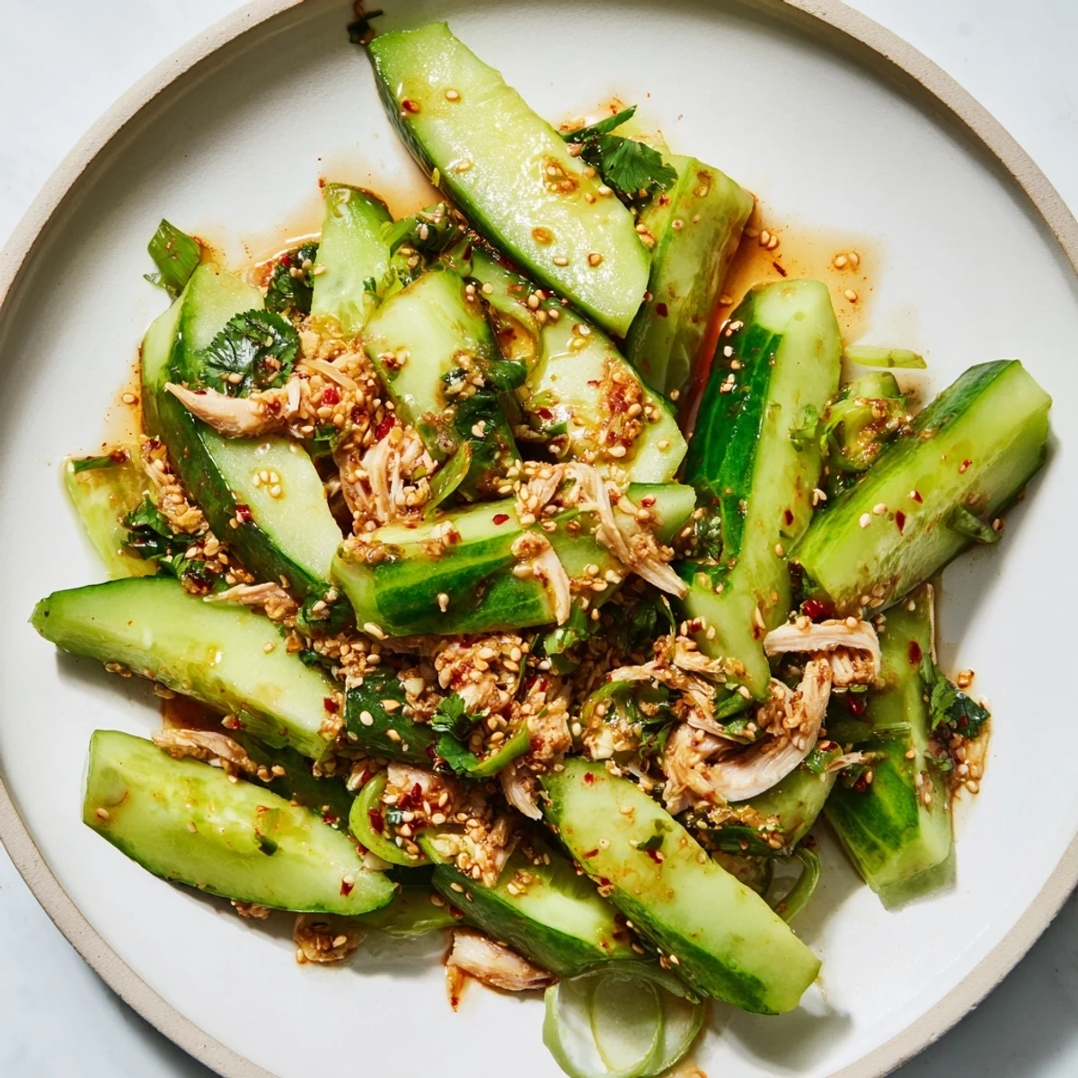 Crispy whole cucumbers in the Whole Cucumber Logan Salad, tossed with savory soy and sesame dressing.
