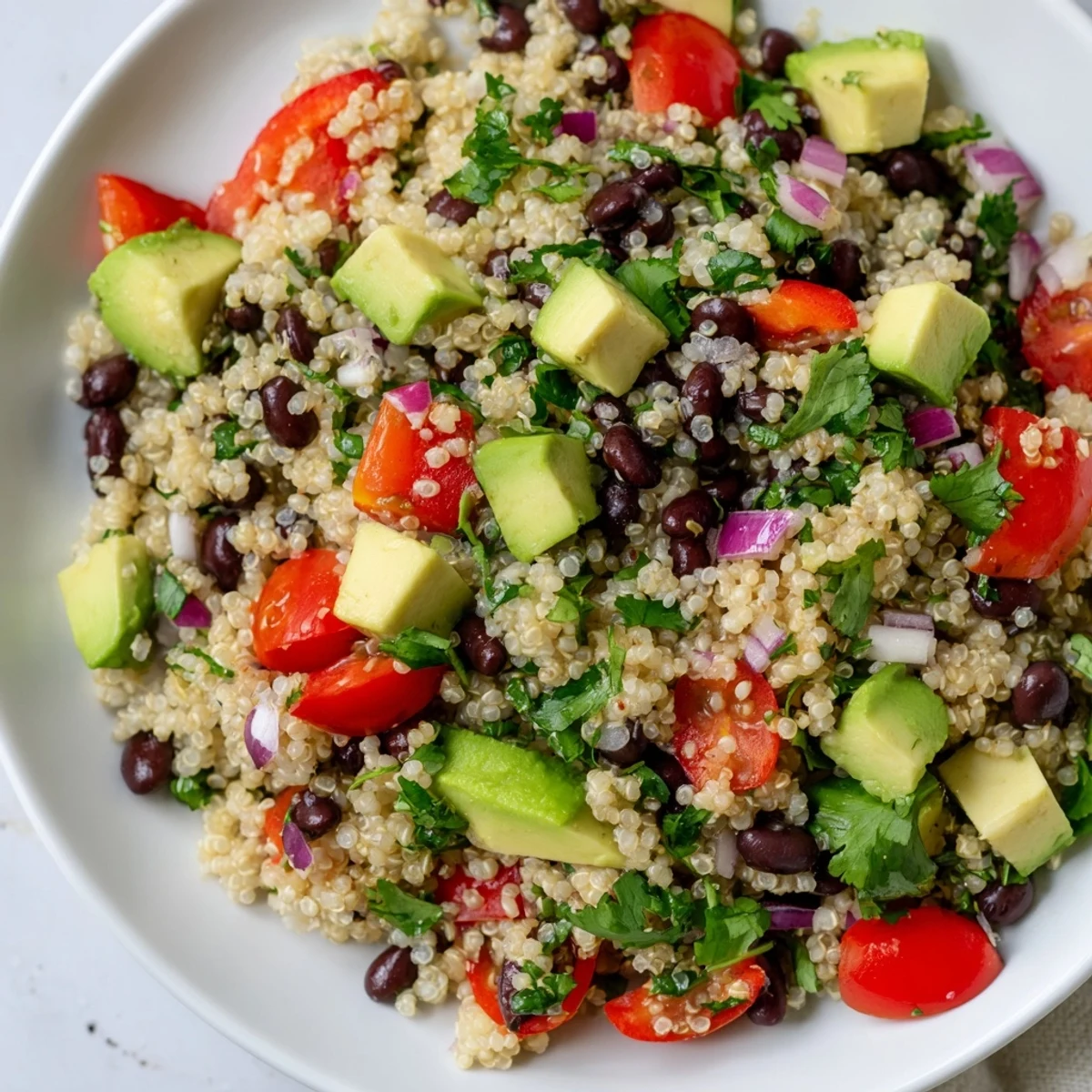 Vibrant Quinoa Black Bean Salad, a refreshing, colorful meal, ready to enjoy with a lime dressing.
