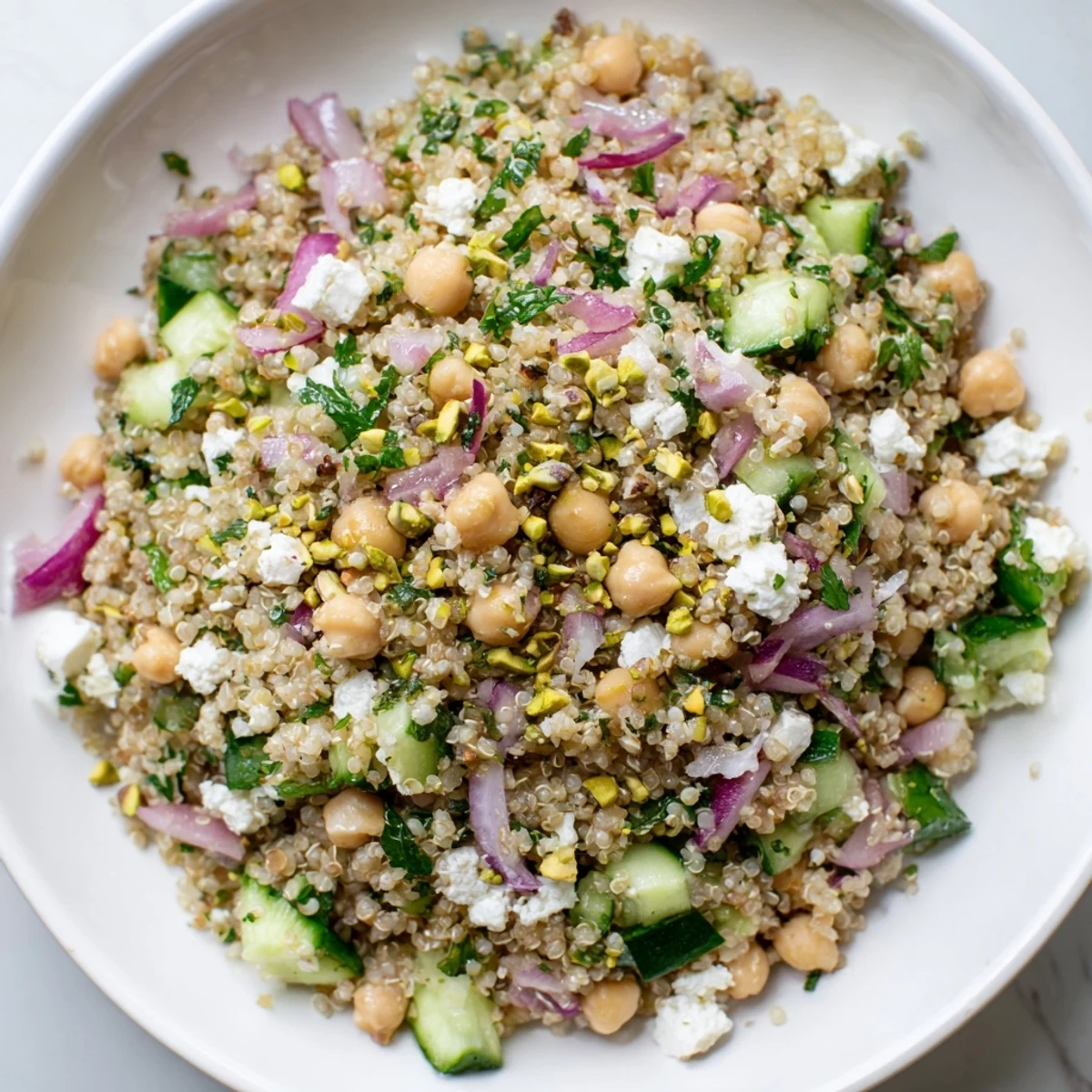 A colorful bowl of Jennifer Aniston Salad, full of chickpeas, herbs, and a zesty dressing.