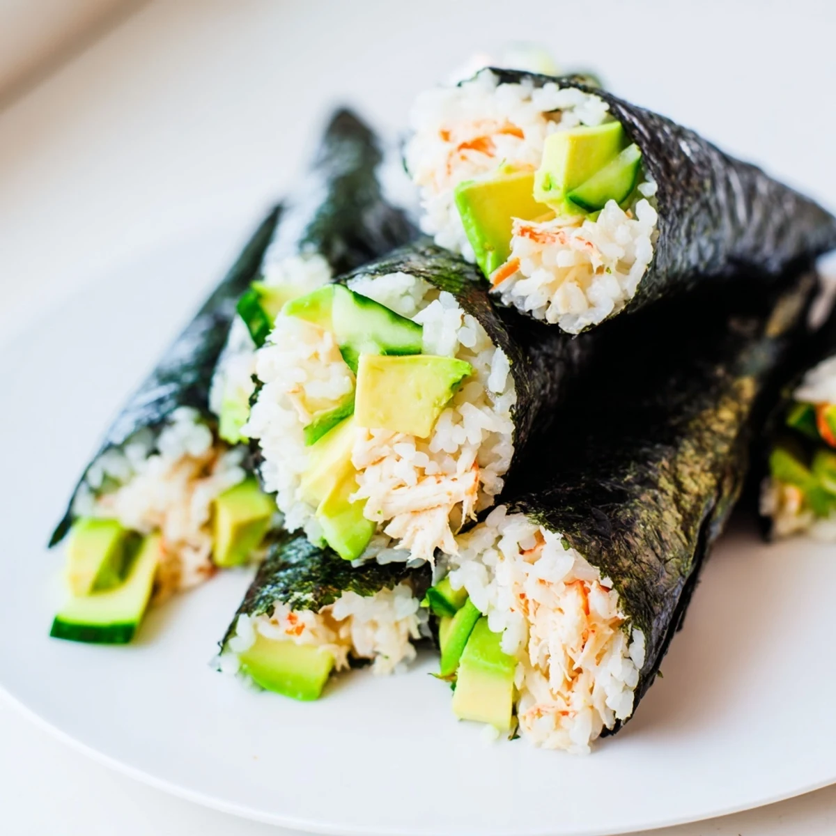 Sushi Rice Hand Rolls filled with seasoned rice, shredded crab, and fresh vegetables served with soy sauce and wasabi.  