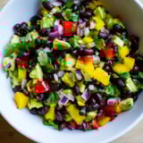 Close-up of a vibrant Southwest Black Bean Salad, speckled with fresh cilantro and sweet corn.