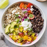 Hearty vegetarian brown rice burrito bowl served with sour cream, cilantro, and fresh lime wedges.  