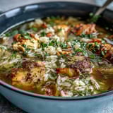 A steaming bowl of Easy Chicken and Rice Soup, brimming with tender chicken, hearty rice, and colorful vegetables in a savory broth.