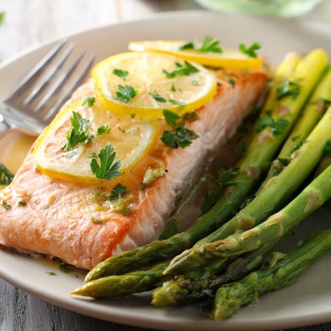 Juicy One-Pan Lemon Garlic Salmon with Asparagus, garnished with fresh parsley.  