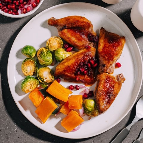 Sheet-pan roasted turkey breast with winter veggies, glistening with sweet cranberry glaze.