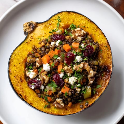 Golden-baked Lentil & Walnut Stuffed Acorn Squash, brimming with savory lentil filling and walnuts.