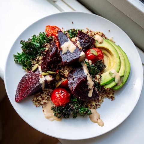 Vibrant quinoa, kale & roasted beet bowl: imagine the colorful beets nestled beside fluffy quinoa with creamy dressing.