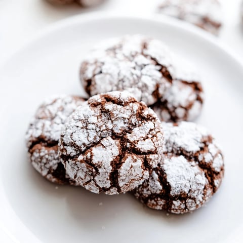 Fudgy Chocolate Gingerbread Crinkle Cookies dusted in powdered sugar, ready to be enjoyed.