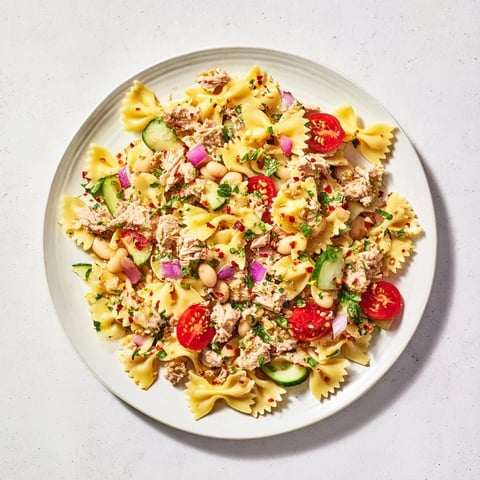 Flaky tuna and white beans mingle in this vibrant Spicy Tuna and White Bean Pasta Salad.