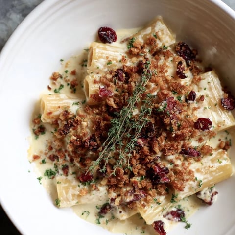 Cranberry and Brie Tartlet Pasta with a golden, crumbly topping and vibrant red cranberries.