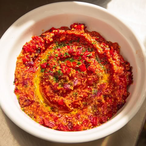 A vibrant bowl of Volcanic Lava Spicy Dip with a swirl, ready for dipping and sharing.