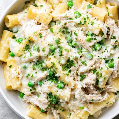 Slow Cooker Chicken Alfredo Pasta Bake: creamy, bubbling, cheesy dish with tender chicken and pasta.