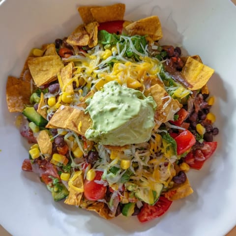 Steaming Veggie-Packed Taco Skillet with a creamy avocado yogurt sauce, ready to be enjoyed.