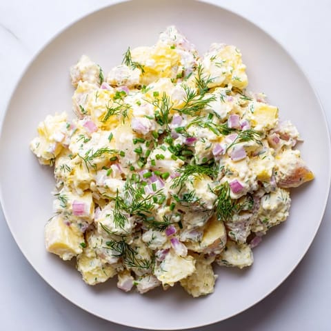Tangy chopped egg and potato salad, featuring bright yellow potatoes and perfectly cooked eggs.