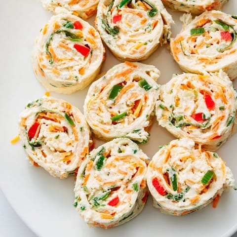 These Cozy Scarf Holiday Pinwheel Wraps look delicious, featuring a variety of textures and bright colors.