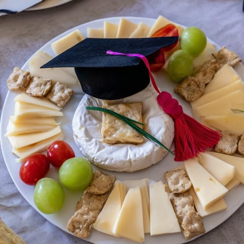 Artistic Graduation Cap Platter appetizer with cheese, olives, and grapes; perfect for a grad party.