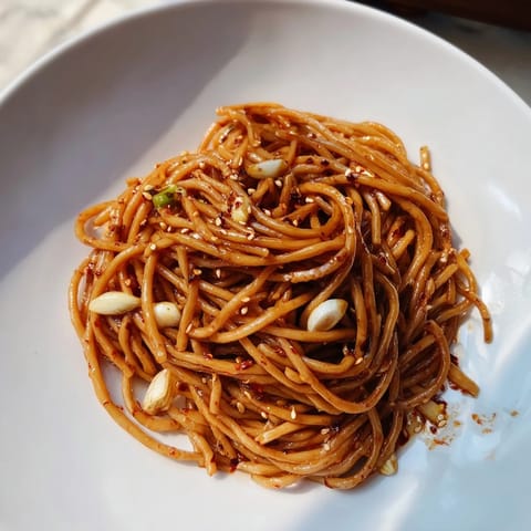 Spicy and glossy Garlic Chili Oil Noodles, full of flavor, offering a satisfying, quick vegan dinner.