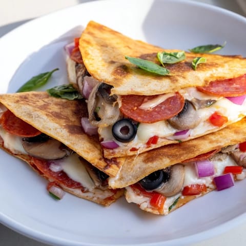 Flavorful tortilla pizza wrap, featuring gooey cheese, folded with savory toppings, and pan-crisped to perfection.