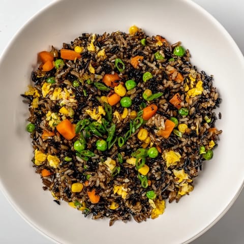 Golden, caramelized black garlic fried rice topped with scallions and a sunny-side-up egg.  
