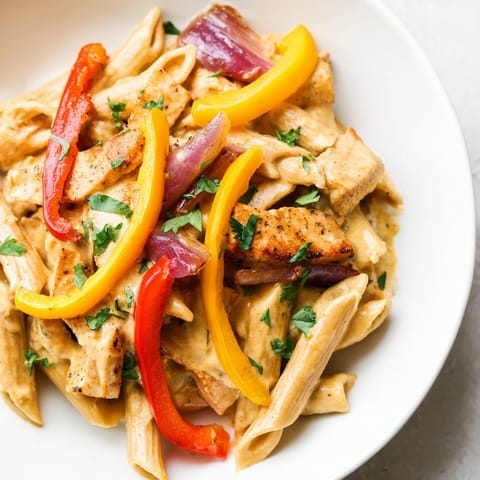 A hearty skillet meal of Fajita Chicken Pasta, featuring tender chicken and vibrant peppers in a rich sauce.