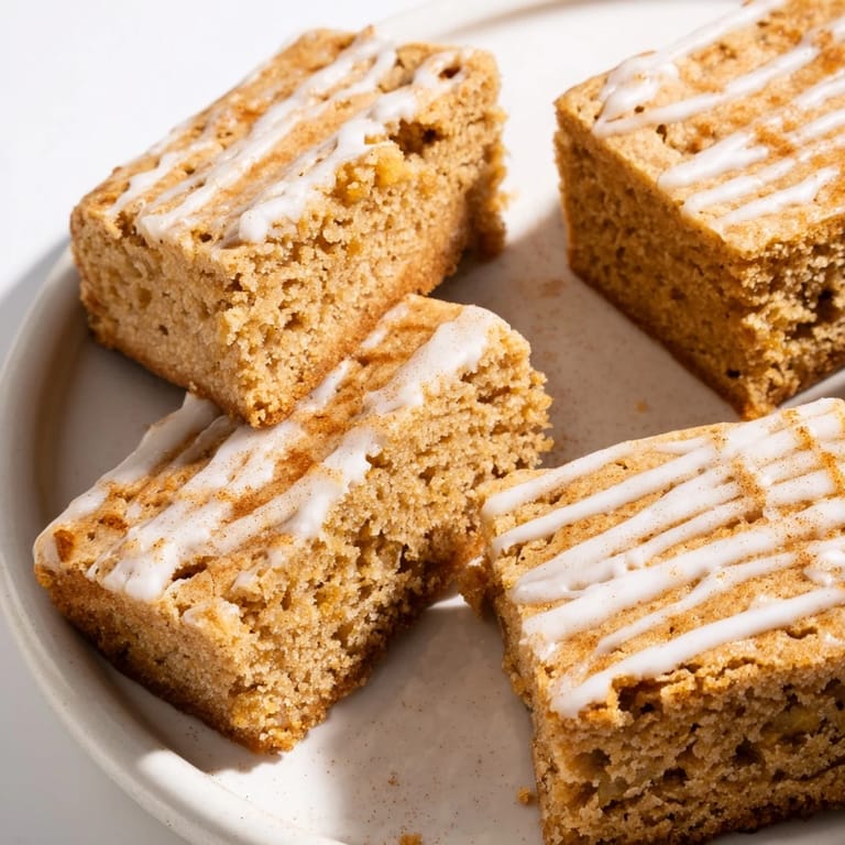 Warm gingerbread bars infused with chai spices, topped with sweet glaze delight.  