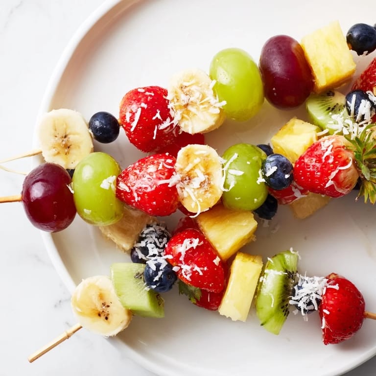 These Easy Festive Fruit Kabobs, with juicy grapes and pineapple, look refreshingly perfect for a summer picnic table.