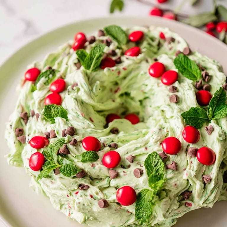 Cool creamy Mint Chocolate Chip Dip Wreath, a dessert perfect with cookies and festive garnishes.