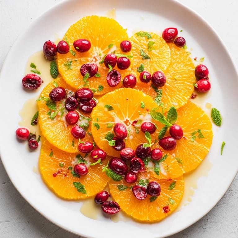 Freshly assembled Winter Fruit salad: a colorful mix of citrus, cranberries, and a sweet drizzle.