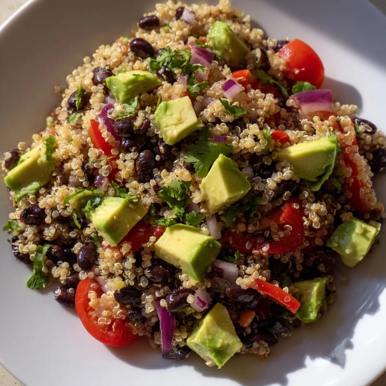 This Quinoa Black Bean Salad features fluffy quinoa, bursting with fresh vegetables and zesty flavors.
