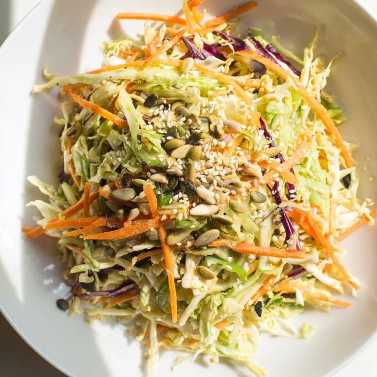 Delicious Cabbage-Core Slaw Salad, a vegan-friendly, Asian-inspired dish with toasted seeds on top.