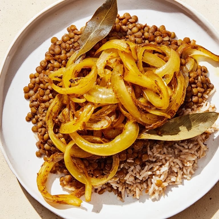 A warm plate of Lebanese Mjadra with perfectly cooked lentils, rice, and sweet, soft onions.