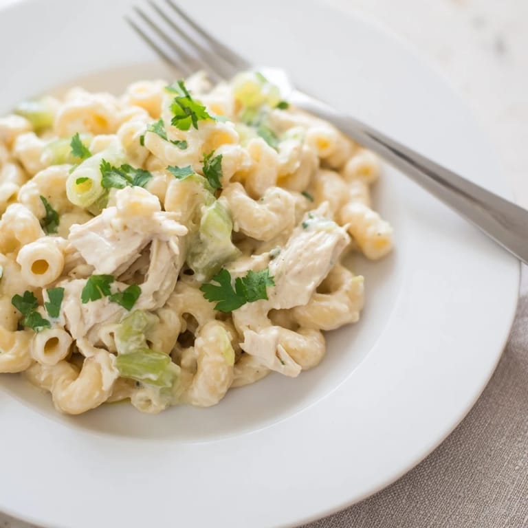 Savory, Southwestern-inspired Green Chili Chicken Mac pasta bake featuring a creamy cheese sauce and hearty diced chicken.