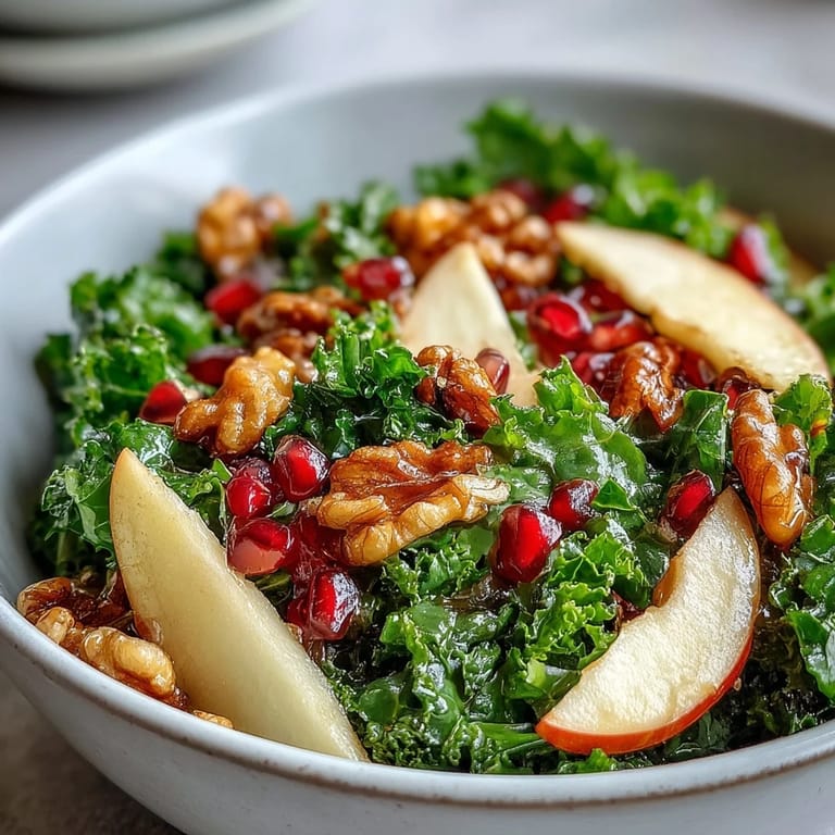 Vibrant Kale and Pomegranate Bowl served ready to eat, highlighting the juicy seeds and fresh greens on a simple white plate.