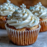 Communion cupcakes with white fondant cross toppers, frosted in creamy buttercream for a festive religious celebration.